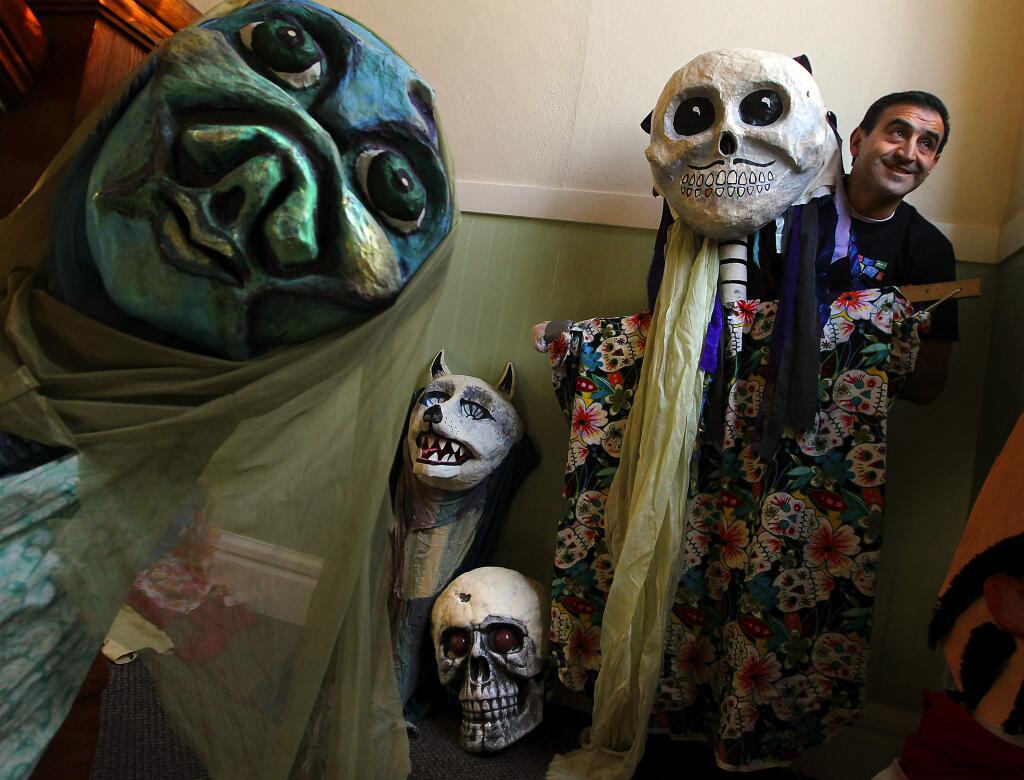 PHOTO: 1 by JOHN BURGESS / The Press Democrat -Abraham Solar with puppets for Petaluma's Dia de los Muertos processional on Nov. 1.