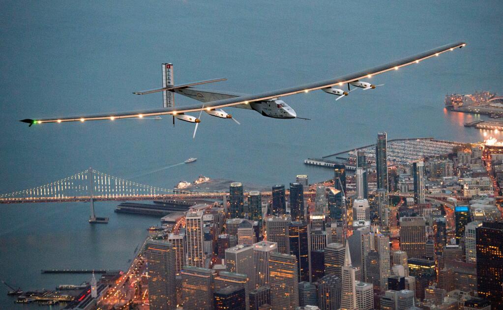 FILE - In this April 23, 2016 file photo, Solar Impulse 2 flies over San Francisco at the end of its journey from Hawaii, part of its attempt to circumnavigate the globe. The next leg of the solar-powered around-the-world flight is scheduled to start from Mountain View, Calif., Monday, May 2, 2016, at 5 a.m. PDT, bound for Phoenix.(AP Photo/Noah Berger, File)