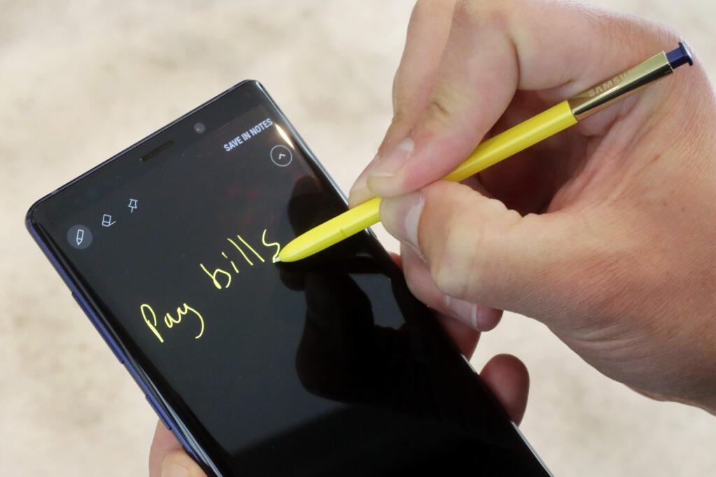 The Samsung Galaxy Note 9 and stylus are shown in this photo, in New York, Tuesday, Aug. 7, 2018. The stylus, a signature Note feature, will now have Bluetooth capability, allowing people to control phones and apps from up to 30 feet away. (AP Photo/Richard Drew)