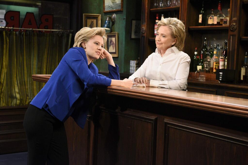 In this Saturday, Oct. 3, 2015, photo, provided by NBC, Kate McKinnon, left, portraying Hillary Rodham Clinton, and Hillary Rodham Clinton, right, portraying Val, appear during the 'Bar Talk' sketch on 'Saturday Night Live,' in New York. Most political candidates play themselves on 'SNL,' often for just a cameo in a sketch or to declare the show's famous tag line, 'Live from New York, it's Saturday night!' Seldom do they play a character in a sketch, as did Clinton. (Dana Edelson/NBC via AP)