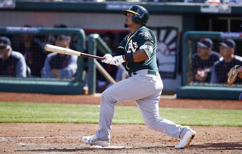 The Oakland Athletics' Franklin Barreto watches the flight of his triple against the Cleveland Indians during the third inning of a spring training game Tuesday, Feb. 27, 2018, in Goodyear, Ariz. The Indians defeated the Athletics 16-8. (AP Photo/Ross D. Franklin)