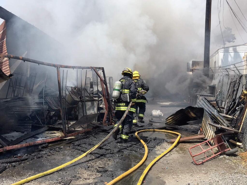 Crews battle a structure fire at McGrath Auction House on Sebastopol Road on Thursday, May 10, 2018. (KENT PORTER/ PD)
