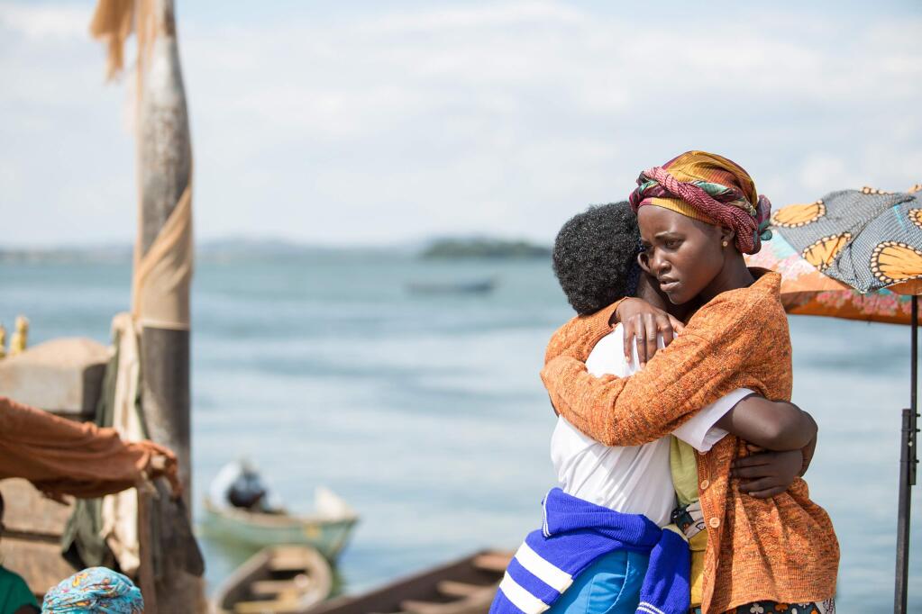 In this image released by Disney, Lupita Nyong'o, right, and Madina Nalwanga appear in a scene from 'Queen of Katwe.' (Edward Echwalu/Disney via AP)