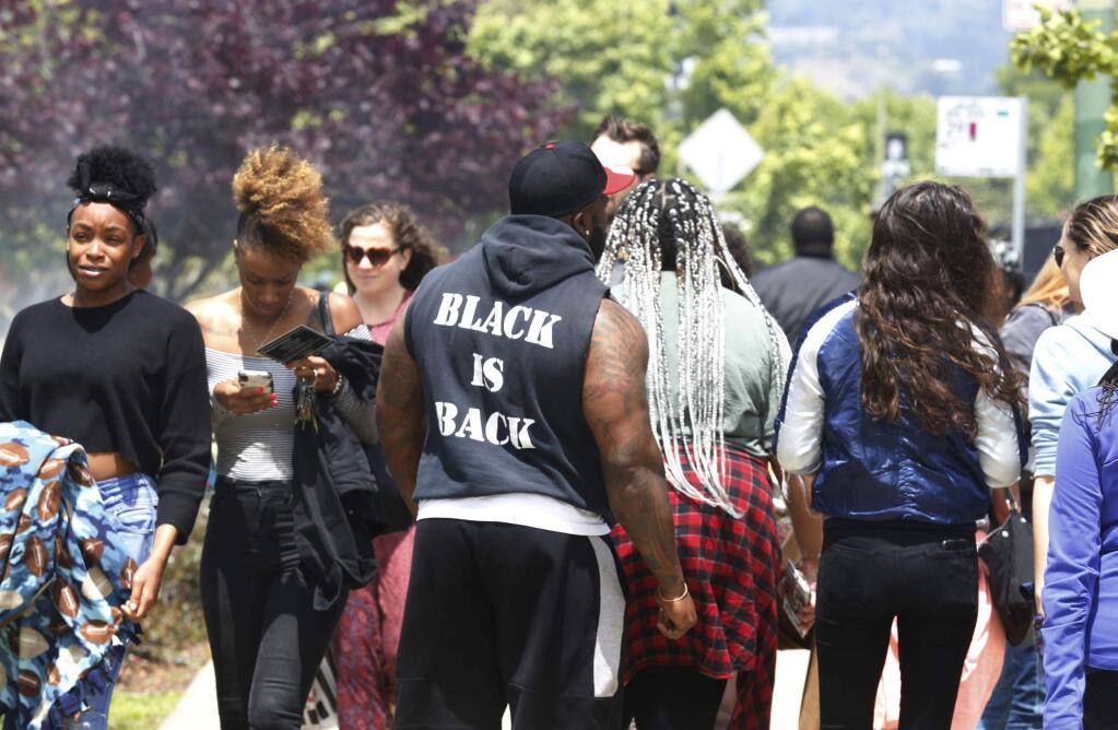 Hundreds attend the 'BBQ-ing while Black' event at Lake Merritt off Lakeshore Avenue in Oakland, Calif., on Sunday, May 20, 2018. Hundreds in the African American community came out to Lake Merritt in response to a confrontation caught on video there a few weeks ago when someone complained to police about a group of black people barbecuing. (Laura A. Oda /East Bay Times via AP)