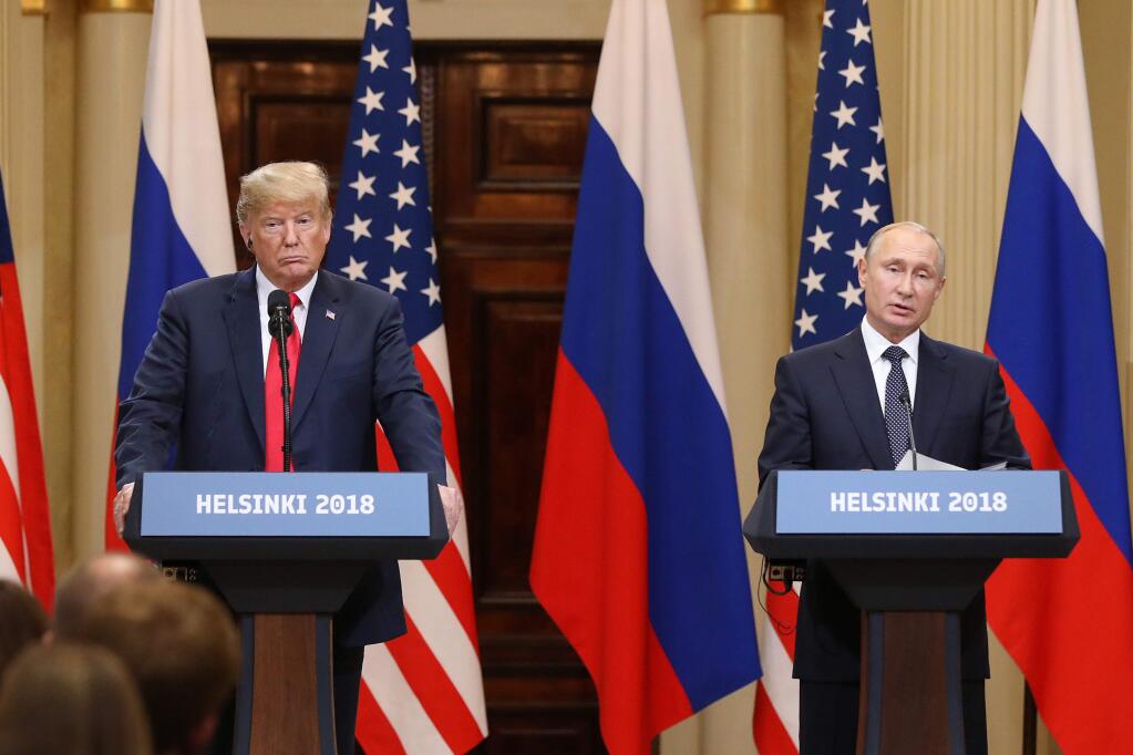 President Donald Trump, left, listens as Vladimir Putin, Russia's president, speaks during a news conference in Helsinki, Finland, on July 16, 2018. MUST CREDIT: Bloomberg photo by Chris Ratcliffe