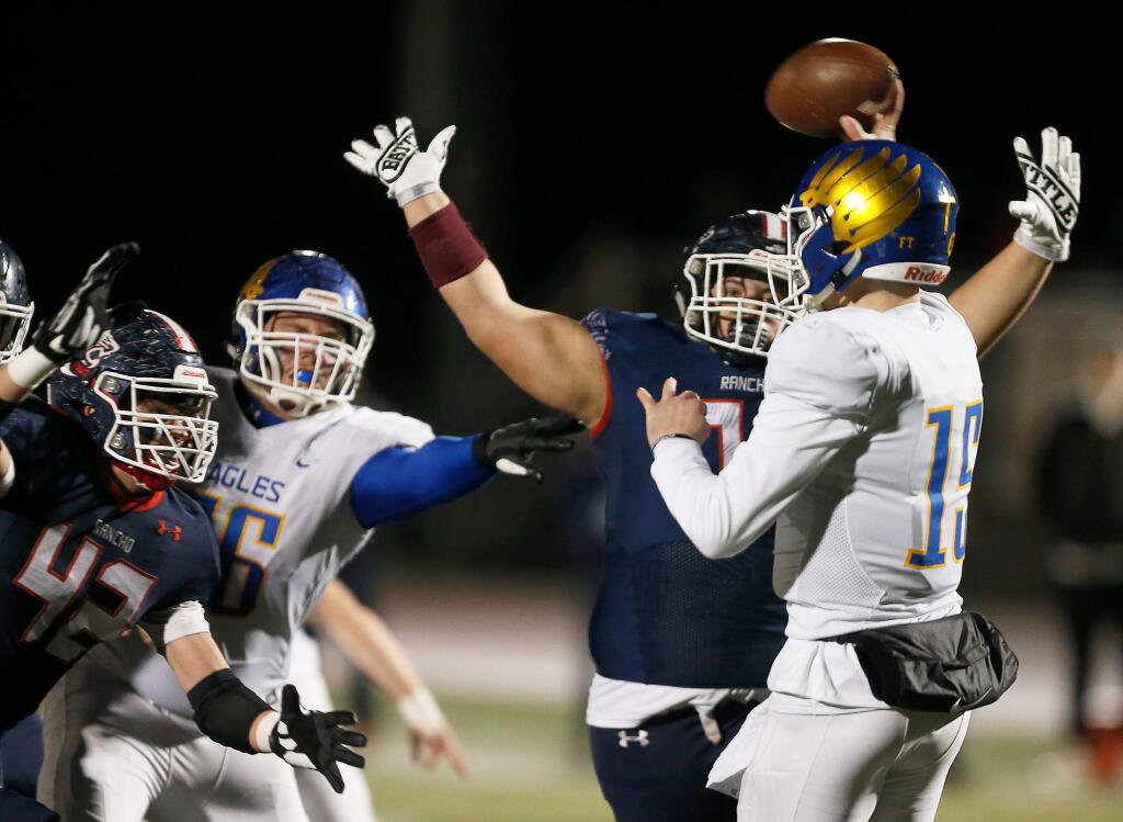 Rancho Cotate's Gino Mencarini (42), left, and Max Jones (71), second from right, pressure Bakersfield Christian quarterback Dominic Gamboni (15) during the first half of the CIF Division 3-A state championship football game between Rancho Cotate and Bakersfield Christian high schools, in Rohnert Park, California, on Saturday, December 14, 2019. (Alvin Jornada / The Press Democrat)
