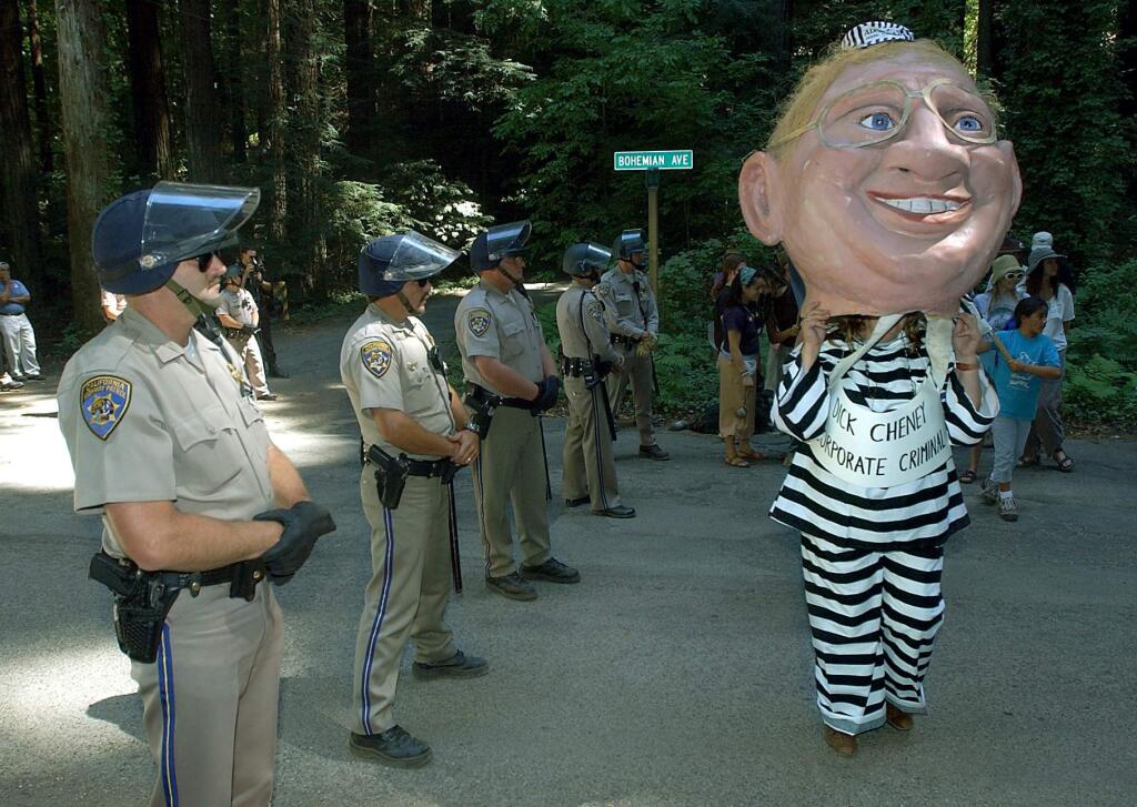 A protester wearing a giant puppet head resembling Dick Cheney outside the Bohemian Grove. (KENT PORTER / The Press Democrat, 2002)
