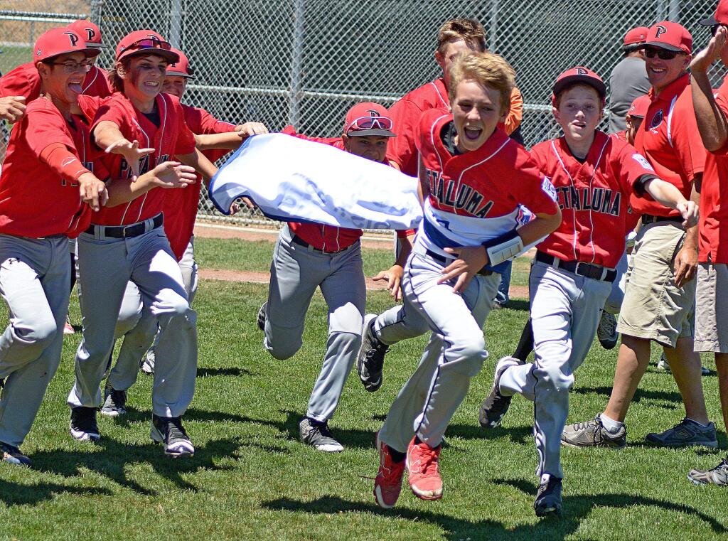 SUMNER FOWLER/FOR THE ARGUS-COURIERA happy group of Petaluma National Major League All-Stars chase the banner they were awarded for winning the District 35 Tournament championship. The Nationals beat Petaluma Valley, 6-1, in the tournament championship game.