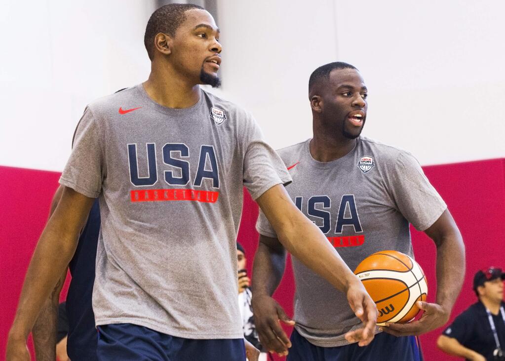 Golden State Warriors teammates Kevin Durant, left, and Draymond Green participate in shooting drills during Team USA basketball practice in Las Vegas on Monday, July 18, 2016. (Benjamin Hager/Las Vegas Review-Journal via AP)