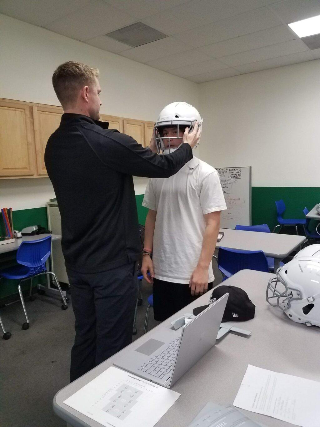 JOHN JACKSON/ARGUS-COURIER STAFFCasa Grande's Jance Offerman gets fitted with his new Vicis ZERO1 helmet. Every player in the Casa football program will be personally fitted with anew state-of-the-art helmet.