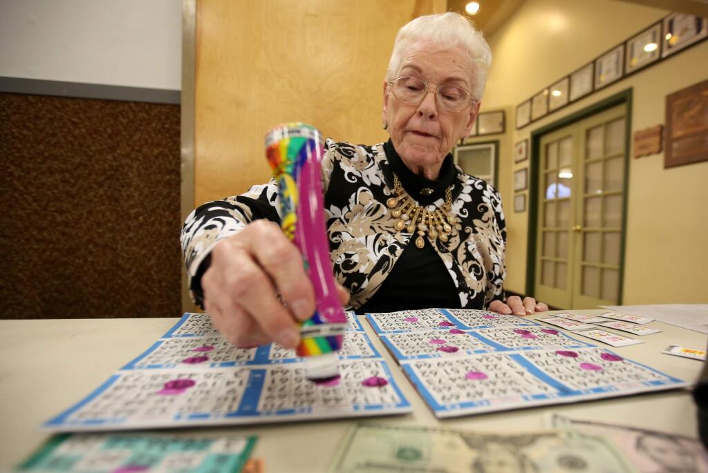 Eleanor Saylor, who has been playing bingo at the Moose Lodge in Sonoma for the last 15 years, daubs her bingo board, Tuesday, February 3, 2015. (Crista Jeremiason/ The Press Democrat)