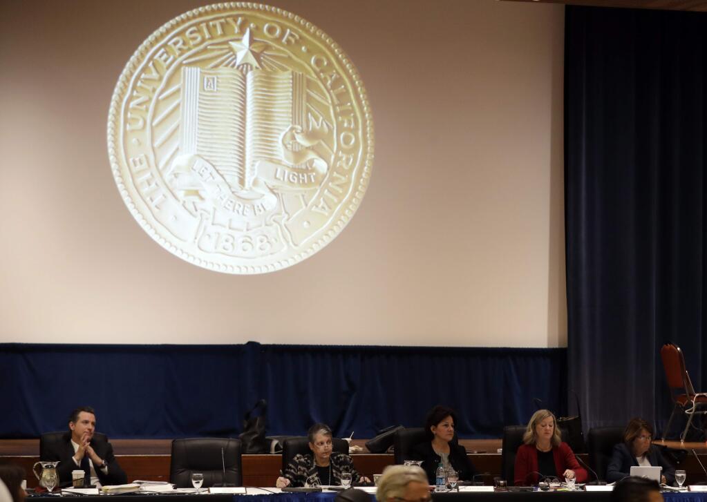 In this Jan. 25, 2017, file photo, members of the University of California Board of Regents listen to testimony from employees and students in San Francisco. The University of California will lower tuition by $60 for the upcoming academic year. The UC Board of Regents approved the decrease Thursday. It's the university system's first tuition decrease in nearly two decades. (AP Photo/Marcio Jose Sanchez, File)