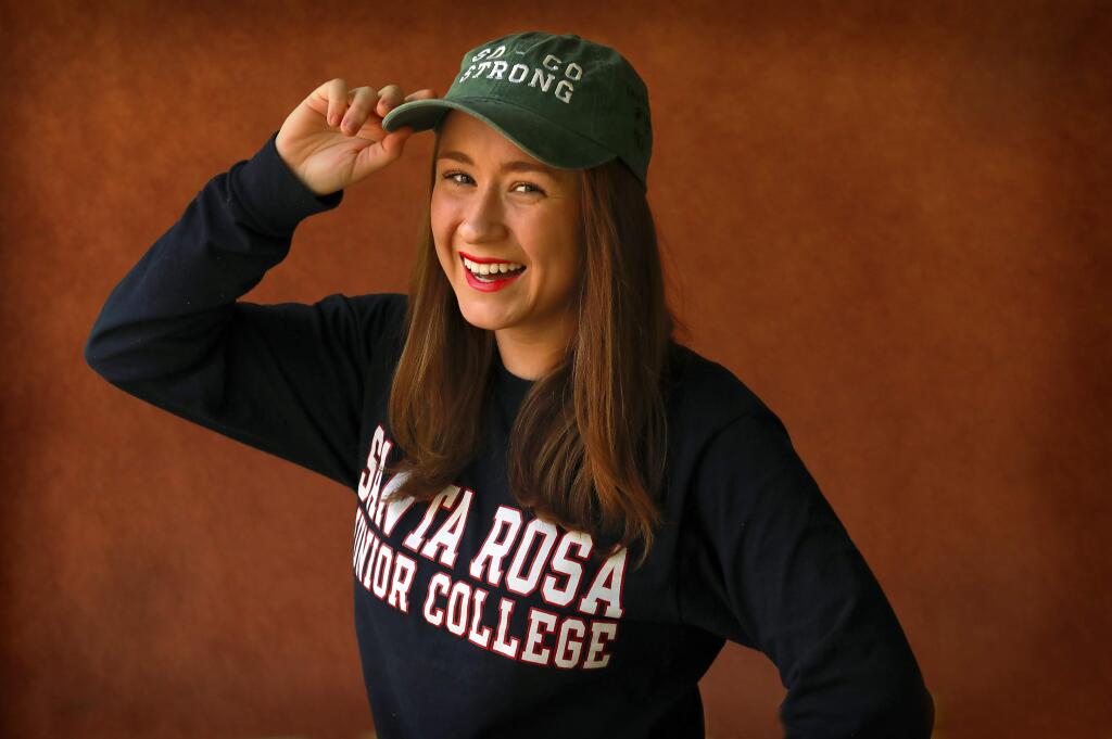 SRJC student Anamaria Morales is selling 'So Co Strong' hats with her design and signed by firefighters to help raise money for low-income Hispanic college students impacted by the wildfires. (photo by John Burgess/The Press Democrat)