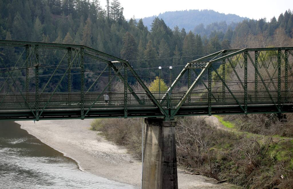A year ago, the Russian River was just under the walkway of the Guerneville pedestrian bridge thanks to a storm that dropped nearly two feet of rain on the watershed. On Wednesday Feb, 20, 2020, the river is running very low due to no February rain. (Kent Porter /The Press Democrat)
