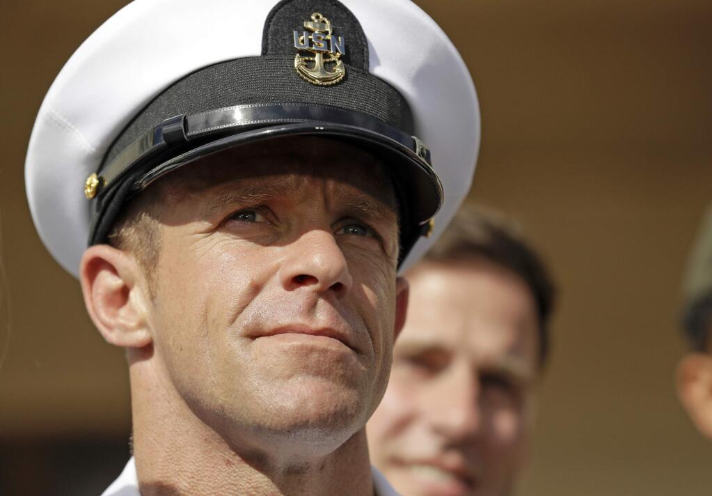 FILE - In this July 2, 2019, file photo, Navy Special Operations Chief Edward Gallagher leaves a military court on Naval Base San Diego. The war crimes case against the Navy SEAL not only cost the Navy secretary his job. It dragged an elite military force whose ethos calls for its warriors to be quiet professionals into a very public and divisive political firestorm. (AP Photo/Gregory Bull, File)