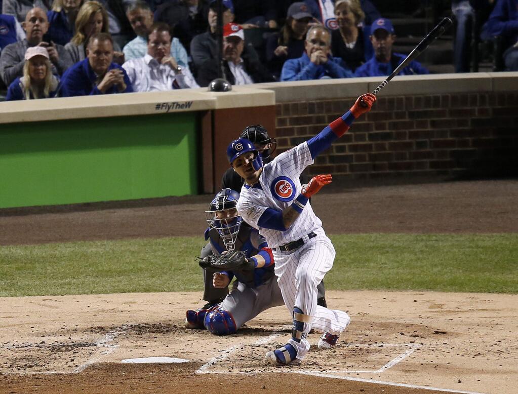 The Chicago Cubs' Javier Baez watches his home run during the second inning of Game 4 of the National League Championship Series against the Los Angeles Dodgers, Wednesday, Oct. 18, 2017, in Chicago. (AP Photo/Charles Rex Arbogast)
