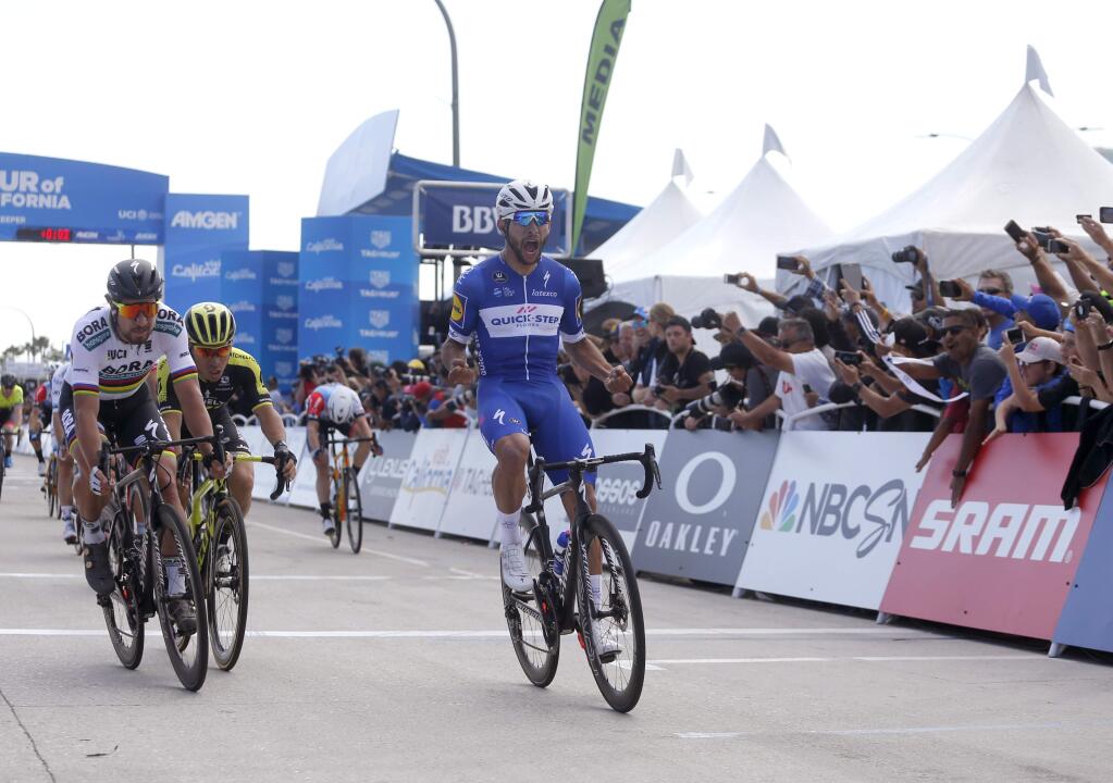 Fernando Gaviria, front, of Colombia, celebrates after crossing the finish line to win the first stage of the Amgen Tour of California cycling race, Sunday, May 13, 2018, in Long Beach, Calif. (AP Photo/Ringo H.W. Chiu)
