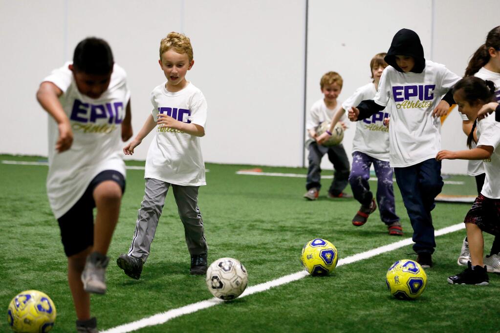 Charles Holden, 8, second from left, and his teammates dribble soccer balls across the field during the Epic Athletes soccer program for special needs children at Epicenter in Santa Rosa on Wednesday, March 27, 2019. (Alvin Jornada / The Press Democrat)