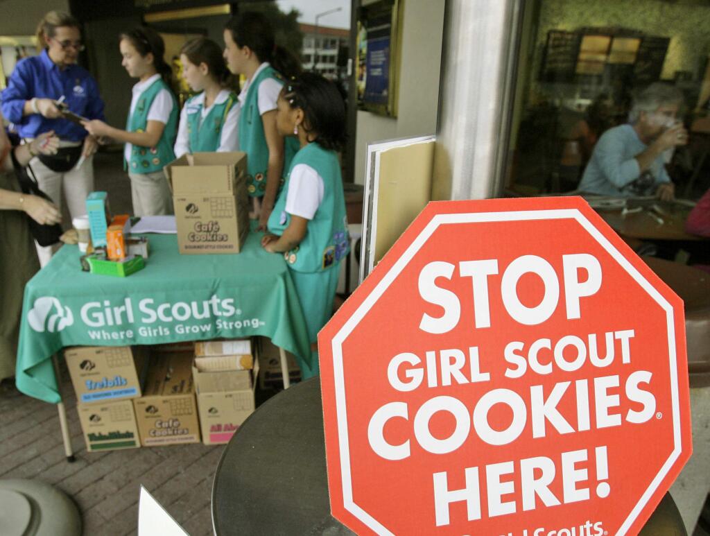 FILE - In this Feb. 23, 2007 file photo, Girl Scouts from the Texas Council sell cookies in Dallas. (AP Photo/Matt Slocum, File)
