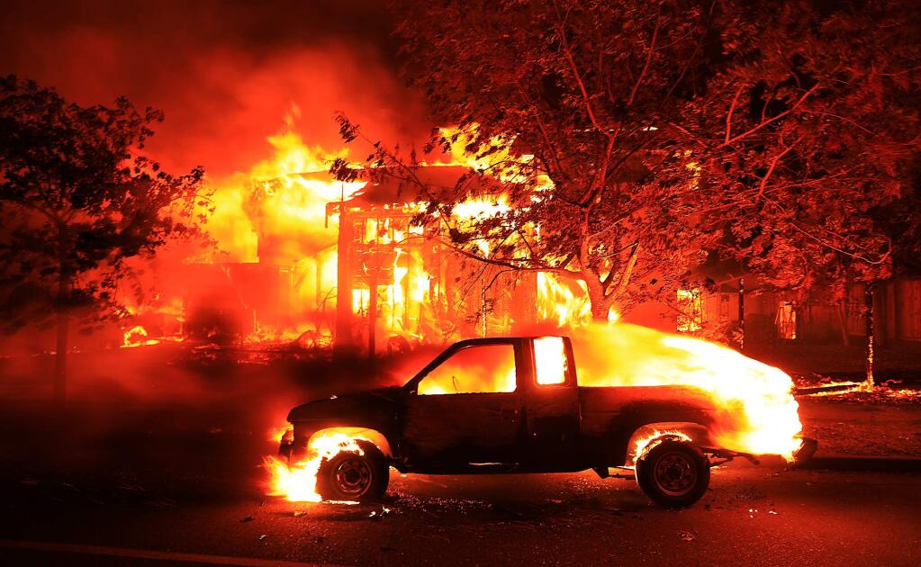 Coffey Park homes burn early Monday Oct. 9, 2017 in Santa Rosa. (Kent Porter / The Press Democrat)