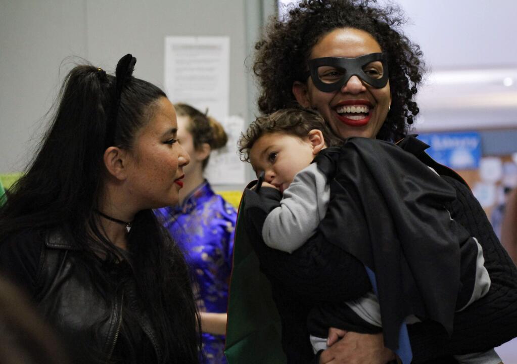 Petaluma, CA. Saturday, January 28, 2017._Dressed as Catwoman, Jeraldine Otero (left) plays with Julian Garcia (as Batman), 17 months, as his mom, Yasi Garcia (Robin) holds him at Lumacon, the third annual Youth Comic Convention in Petaluma.(CRISSY PASCUAL/ARGUS-COURIER STAFF)