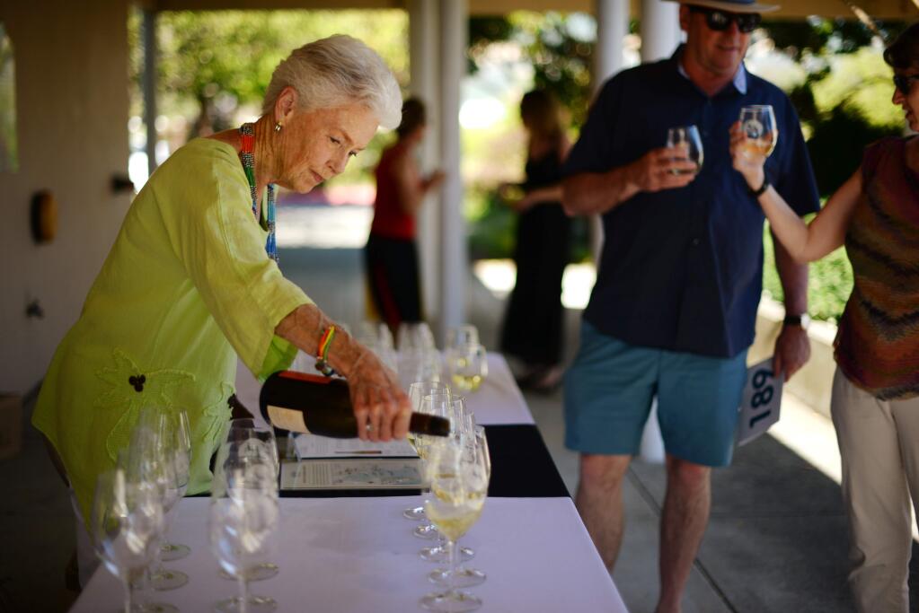 Sally Olson has been volunteering for Canine Companions since 1998 and was pouring Seghesio Family Vineyards 2016 Arneis for guests during Sit Stay Sparkle, an event benefiting Canine Companions for Independence held at the Jean and Charles Schulz Campus in Santa Rosa Saturday. June 17, 2017.(Photo: Erik Castro/for The Press Democrat)