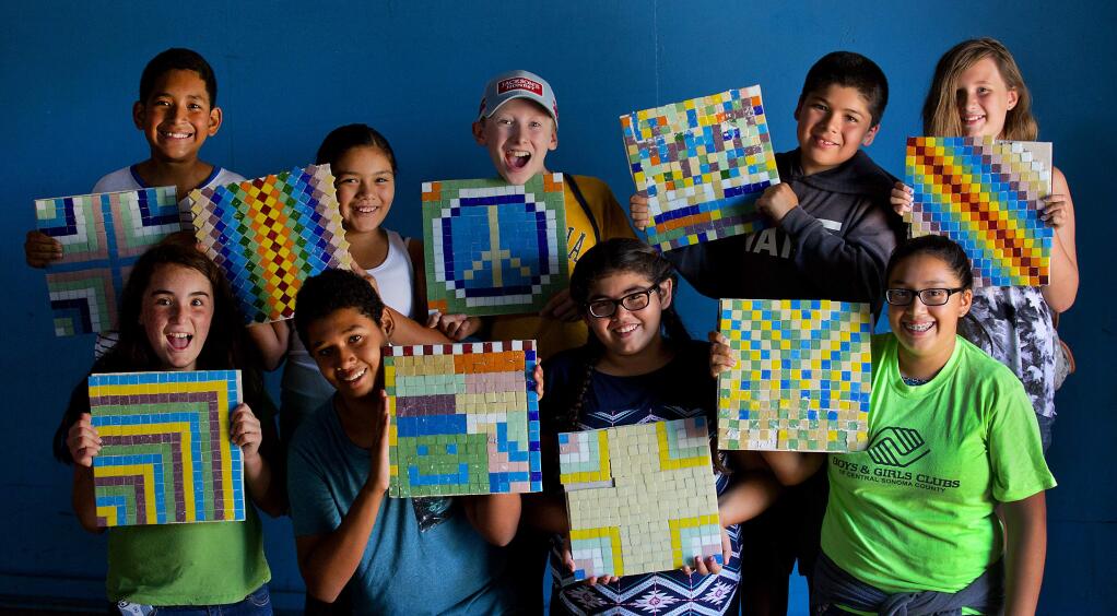 Front row, left to right, Larissa Macario, Matthew Carbajal, Kellie Castro, Ashley Garcia, back row, left to right, Antonio Moo, Clarissa Cano, Liam O'Gorman, Emiliano Adrade and Sophia Martinelli show of the tiles they created at the Boys and Girls Club of Healdsburg. The mosaic tiles will be used to create one large masterpiece at the Healdsburg Center for the Arts. (JOHN BURGESS/The Press Democrat)
