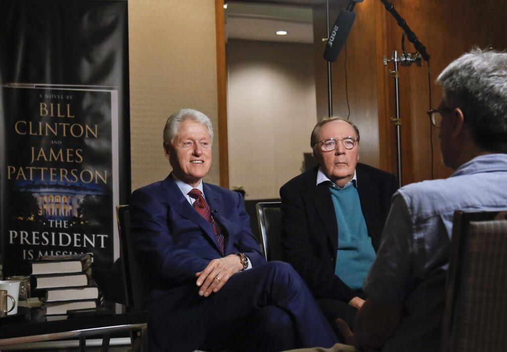 FILE - In this Monday, May 21, 2018, file photo, former President Bill Clinton, left, and author James Patterson speak during an interview about their novel, 'The President is Missing,' in New York. Clinton and Patterson are teaming up again with “The President's Daughter,' to be released in June 2021, the book's publishers announced Thursday. (AP Photo/Bebeto Matthews, File)