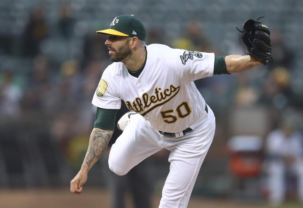 Oakland Athletics pitcher Mike Fiers works against the Texas Rangers in the first inning of a baseball game Monday, Aug. 20, 2018, in Oakland, Calif. (AP Photo/Ben Margot)
