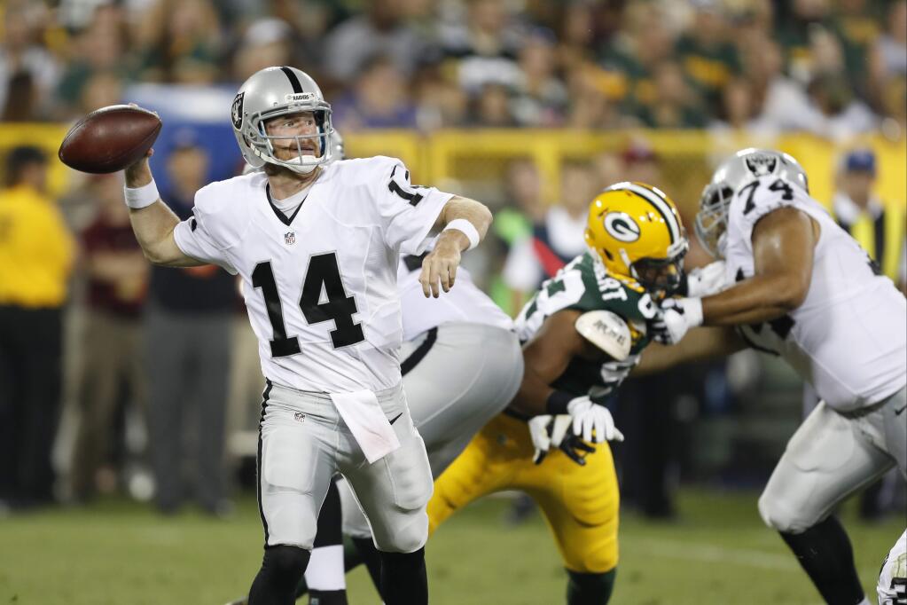 Oakland Raiders quarterback Matt McGloin (14) throws against the Green Bay Packers during the second half of a game in Green Bay, Wis., Thursday, Aug. 18, 2016. (AP Photo/Matt Ludtke)