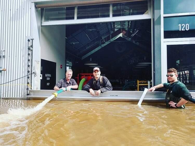 The crew at Seismic helping a neighbor, Crooked Goat, dry out their brewery after recent flooding in Sebastopol. (Courtesy of Seismic Brewing)