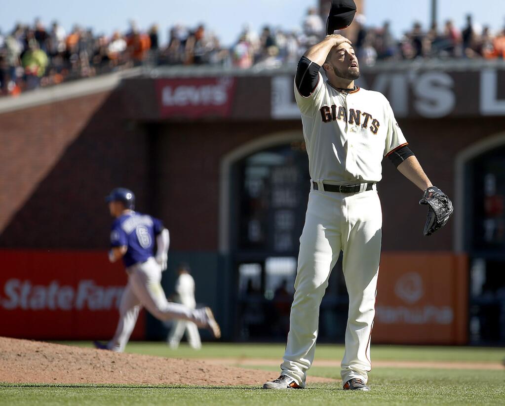 San Francisco Giants pitcher George Kontos reacts on the mound as Colorado Rockies' Corey Dickerson (6) rounds the bases after hitting a 3-run home run in the ninth inning of a baseball game, Sunday, Oct. 4, 2015, in San Francisco. (AP Photo/Tony Avelar)