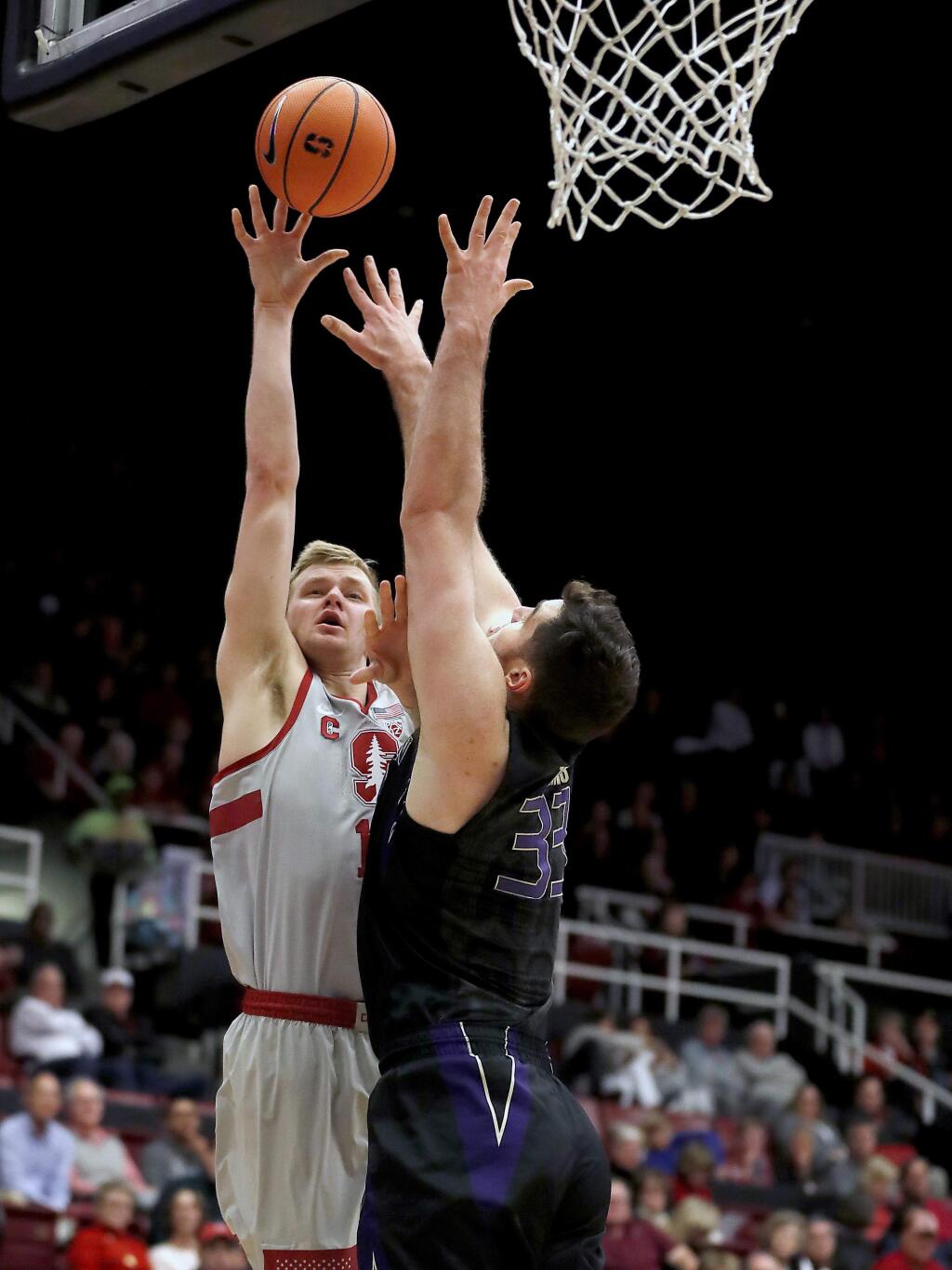 Stanford forward Michael Humphrey (10) takes a shot over Washington forward Sam Timmins (33) during the first half of an NCAA college basketball game Thursday, Feb. 22, 2018, in Stanford, Calif. (AP Photo/Tony Avelar)