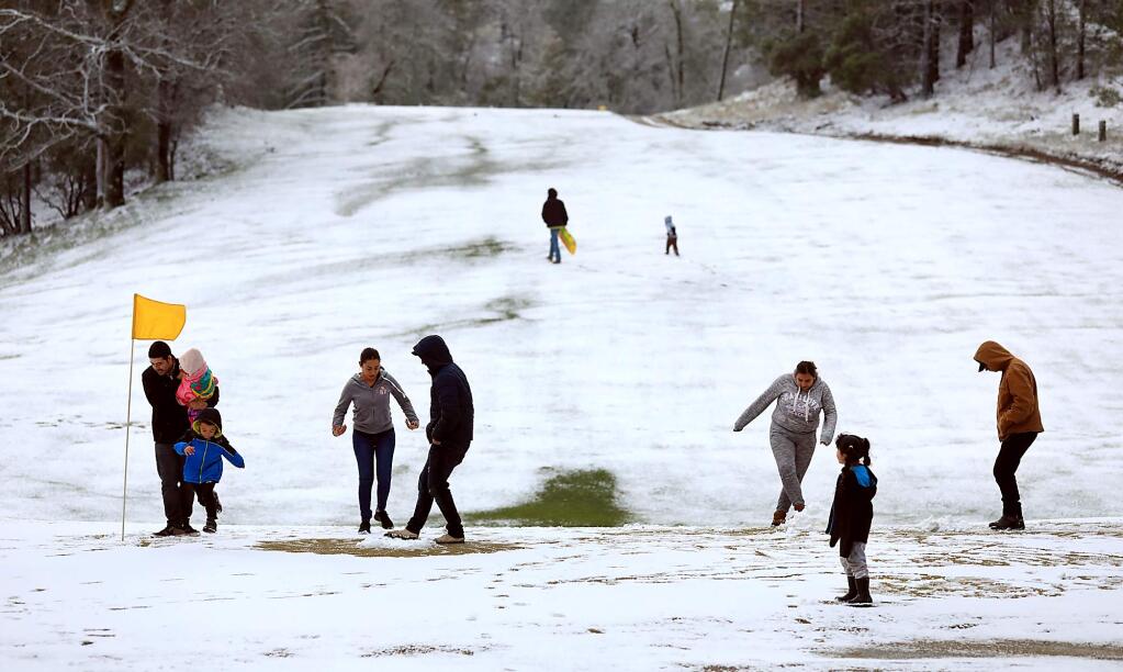 Families enjoy the snow at Adams Springs Golf Course in the Cobb Mountain area on Monday, Feb. 4, 2019. (KENT PORTER/ PD)