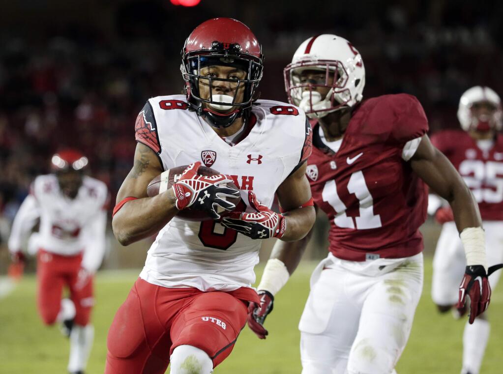 Utah wide receiver Kaelin Clay, center, runs into the end zone with a touchdown catch next to Stanford cornerback Terrence Alexander (11) during overtime of a game on Saturday, Nov. 15, 2014, in Stanford. Utah won 20-17. (AP Photo/Marcio Jose Sanchez)