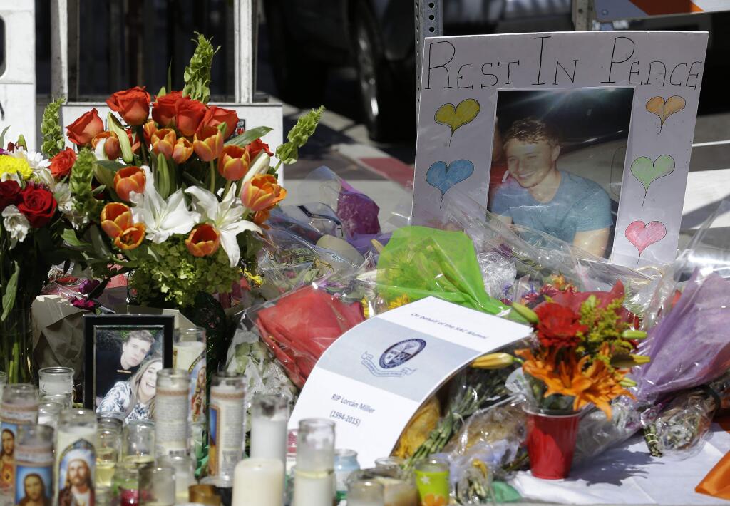 Flowers, cards and photographs are shown at a memorial left for victims of a Library Gardens apartment building balcony in Berkeley, Calif., Thursday, June 18, 2015. A balcony broke loose from an apartment building during a 21st birthday party early Tuesday, killing several and seriously injuring several others. (AP Photo/Jeff Chiu)