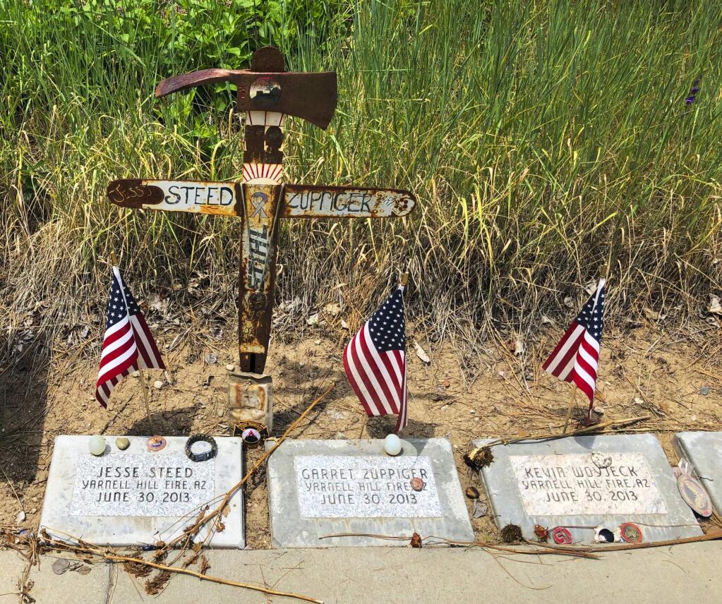 This June 3, 2019 photo shows memorial stones at the Wildland Firefighters Monument at the National Interagency Fire Center in Boise, Idaho, for wildland firefighters killed by a wildfire on June 30, 2013, near Yarnell, Ariz. Federal officials at the NIFC are bolstering mental health resources for wildland firefighters following an apparent increase in suicides. (AP Photo/Keith Ridler)