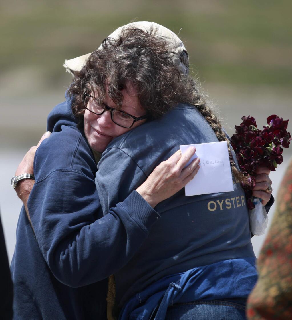 Owner Nancy Lunny, left, hugs supporter Milly Biller after a gathering on the last day of retail sales at Drake's Bay Oyster Company near Inverness, on Thursday, July 31, 2014. (BETH SCHLANKER/ The Press Democrat)
