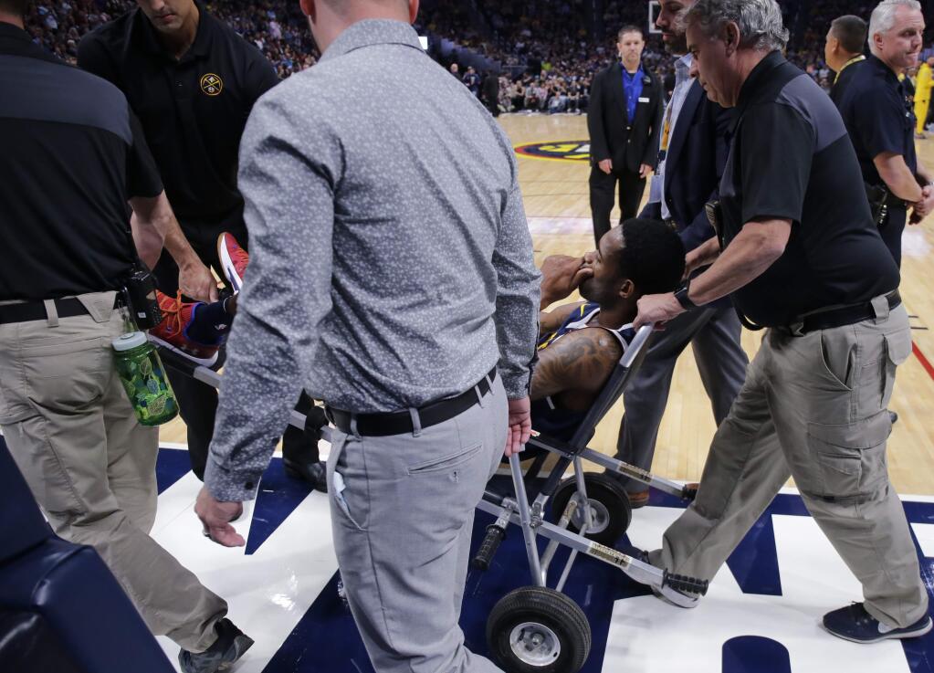 Denver Nuggets guard Will Barton is carted off the court after being injured during the third quarter of an NBA basketball game against the Phoenix Suns, Saturday, Oct. 20, 2018, in Denver. (AP Photo/Jack Dempsey)