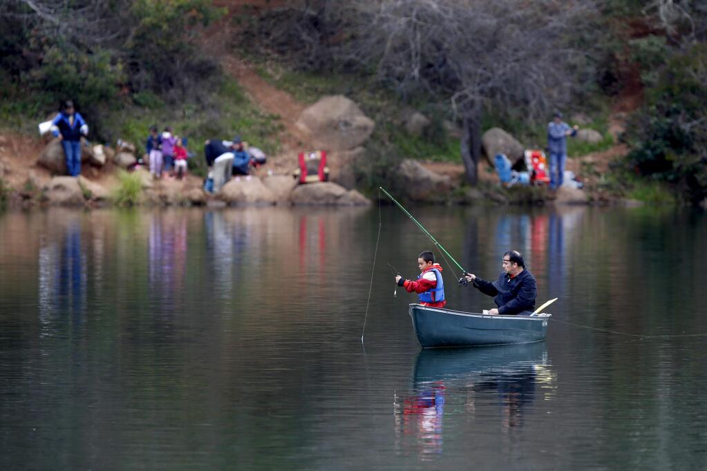 Andres Osorio, 8, and his grandfather Isaac Osuna fish from a canoe during the Fishing Derby at Lake Ralphine at Howarth Park in Santa Rosa, California on Sunday, February 24, 2019 . (BETH SCHLANKER/The Press Democrat)