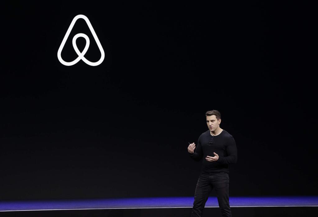 FILE - In this Feb. 22, 2018, file photo Airbnb co-founder and CEO Brian Chesky speaks during an event in San Francisco. Airbnb is laying off 25% of its workforce as it confronts a steep decline in global travel due to the new coronavirus. In a letter to employees, Tuesday, May 5, 2020, Chesky said the company is letting 1,900 of its 7,500 workers go and cutting businesses that don't directly support home-sharing, like its investments in hotels and movie production.(AP Photo/Eric Risberg, File)