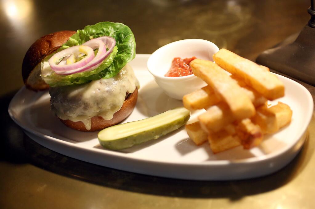 A Grass-fed Ground Beef Burger is served at The Farmer and the Fox in St. Helena, Wednesday, January 21, 2015. (PD FILE)