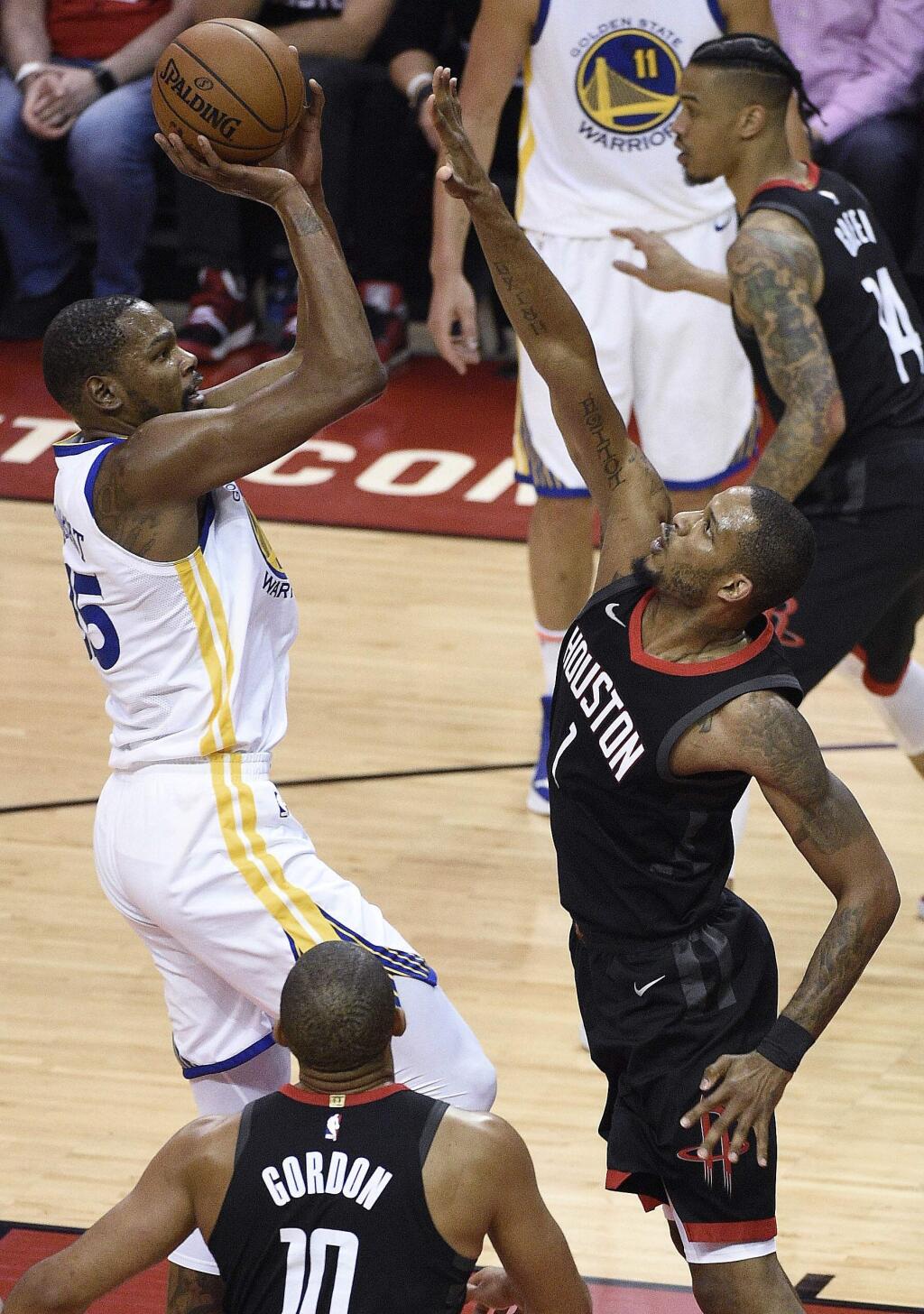 Golden State Warriors forward Kevin Durant, left, shoots as Houston Rockets forward Trevor Ariza defends during the first half of Game 2 of the NBA basketball playoffs Western Conference finals Wednesday, May 16, 2018, in Houston. (AP Photo/Eric Christian Smith)