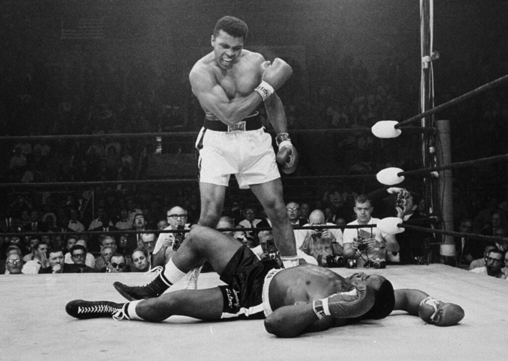 Monday, May 25 is the 50th Anniversary of the iconic heavyweight match between Muhammad Ali and Sonny Liston, in which Ali dropped Liston less then two minutes into the first round of the match. In this May 25, 1965 file photo, heavyweight champion Muhammad Ali stands over fallen challenger, Sonny Liston, shortly after dropping him with a short hard right to the jaw in Lewiston, Maine. In 1964 he changed his name from Cassius Clay and adopted his Muslim name. (AP Photo/John Rooney)
