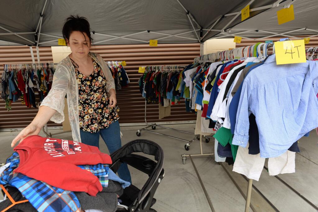 'I need clothes for my kids for the summer,' said Kimberly Pritchett of Rohnert Park, who took clothes for her five children during a giveaway of used children's clothing to families in need held at Expressway Self Storage in Rohnert Park Sunday. Organizers said they may try to do this giveaway on the last Sunday of each month. June 25, 2017. (Photo: Erik Castro/for The Press Democrat)