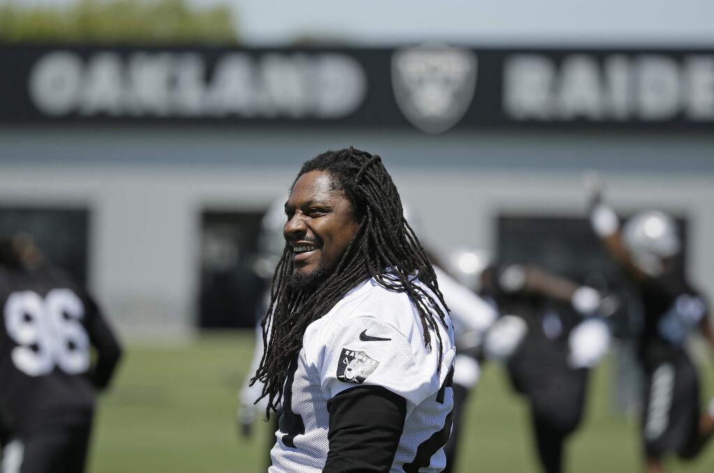 Oakland Raiders running back Marshawn Lynch stretches during organized team activities Tuesday, May 23, 2017, in Alameda. (AP Photo/Eric Risberg)