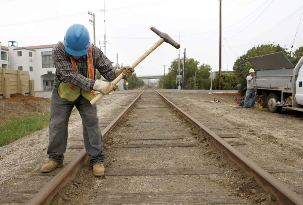 Jorge Jimenez, a worker with Northwestern Pacific Railroad Company, hammers spikes as he does maintenance on the railroad on Tuesday, October 19, 2010, in Novato, California. (BETH SCHLANKER/ The Press Democrat)