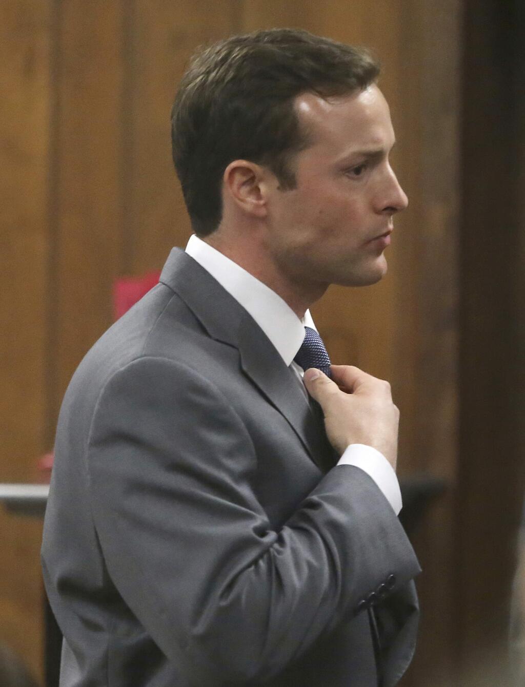 Former Baylor University fraternity president Jacob Anderson adjust his tie in the courtroom Monday Dec. 10, 2018 in Waco, Texas. Mr. Anderson, accused of rape, will serve no jail time after a Waco district judge accepted a plea bargain for deferred probation. (Jerry Larson/Waco Tribune Herald via AP)