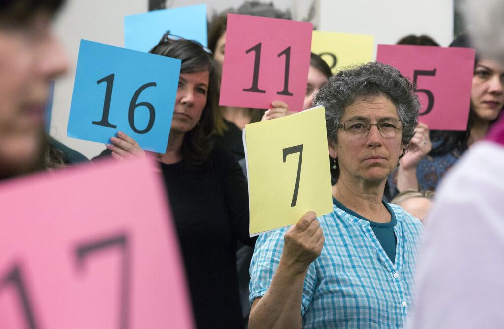 Robbi Pengelly/Index-TribuneTeachers in the Sonoma Valley Unified School District held up numbers at the Feb. 13, school board meeting signifing the number of teaching positions (22) that could be cut under a proposed $2.5 million budget cut.