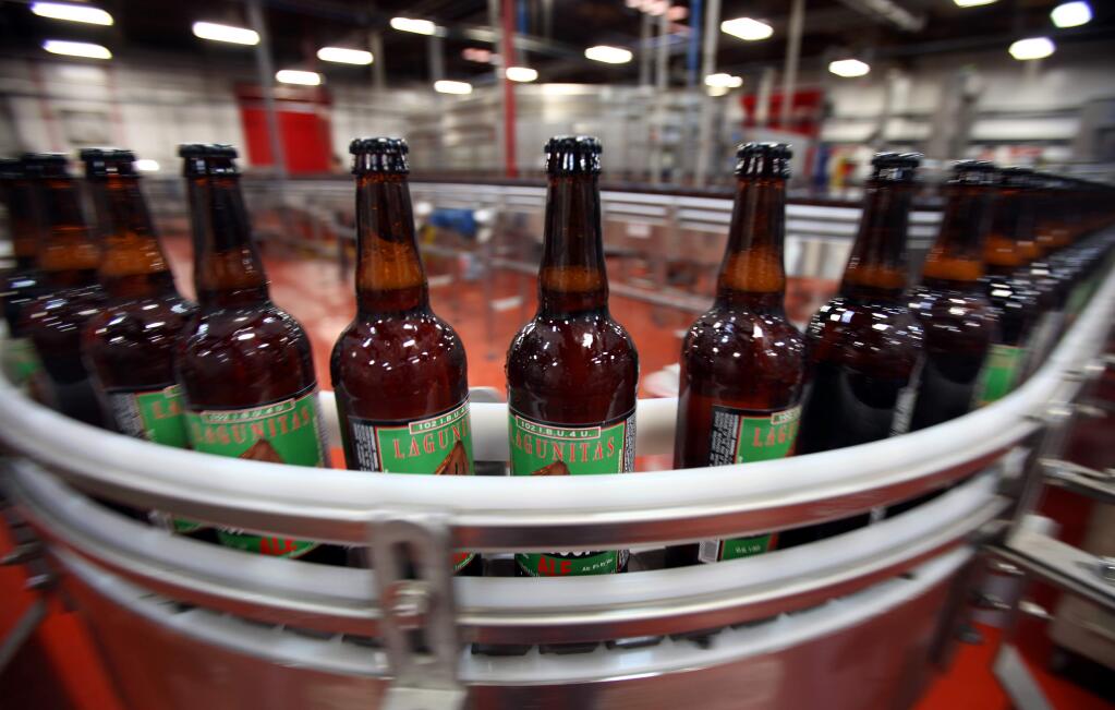 Bottles are filled and labeled along the production line at Lagunitas Brewing Company in Petaluma, on Tuesday, April 23, 2013. (Christopher Chung/ The Press Democrat)